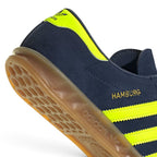 Highlights the clean finish of the tread architecture, showing the recessed circular pivot point, raised honeycomb suction pods, and debossed adidas lettering along the gum cupsole border.