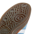Close-up of Adidas shoe sole with pattern and brand logo.