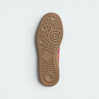 Displays the technical geometric traction grid of the indoor rubber outsole, engineered for unreal everyday street grip.