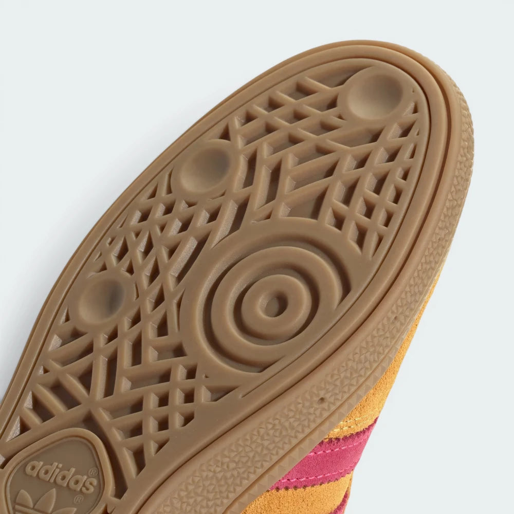 Close-up of Adidas sneaker sole with brand logo on a white background