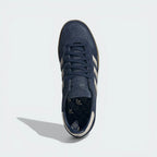 Looking down at the navy leather lacing system and the premium branding on the tongue.