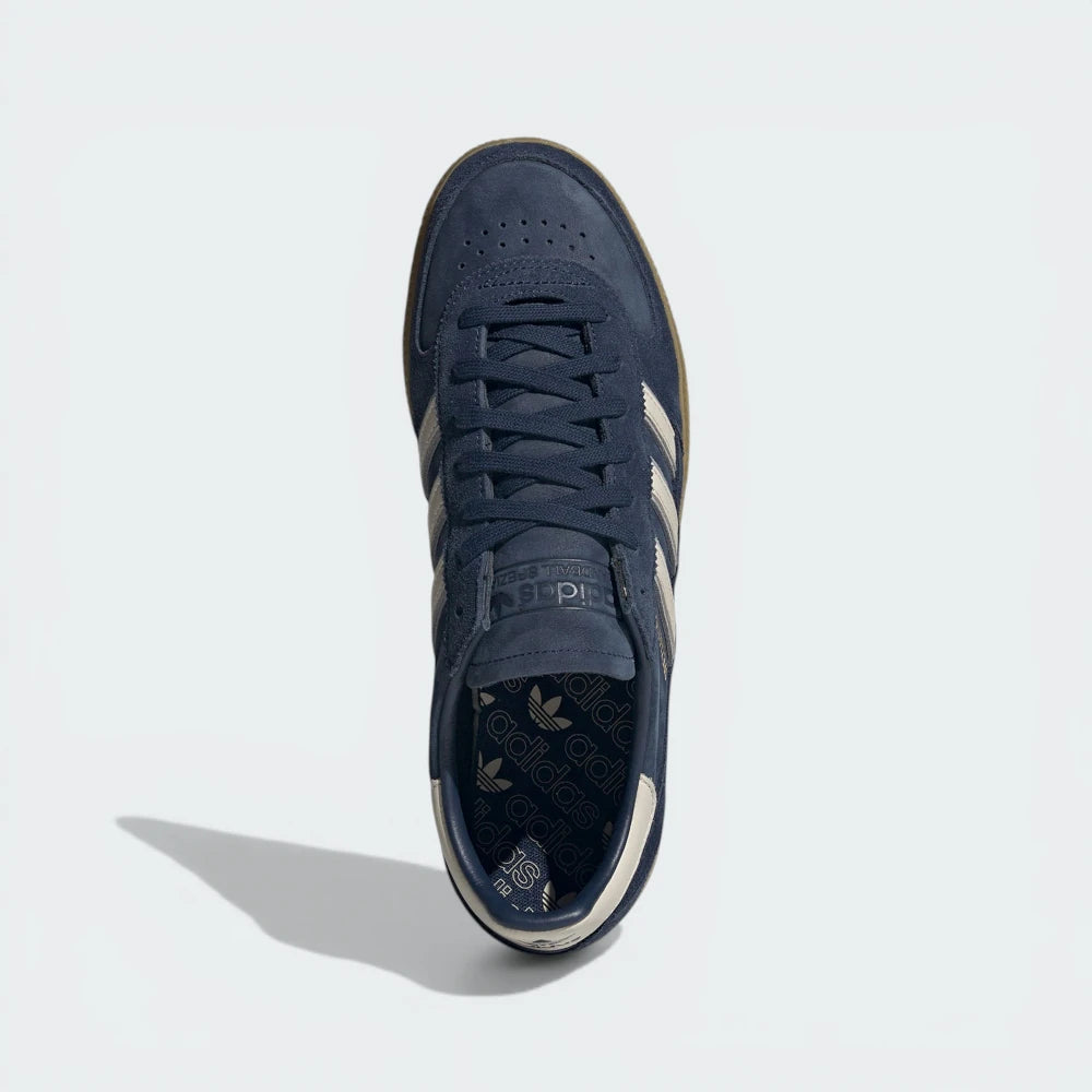 Looking down at the navy leather lacing system and the premium branding on the tongue.