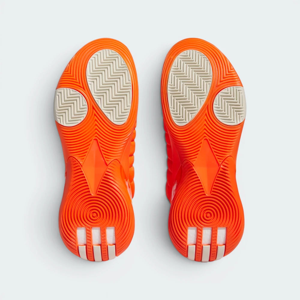 Displays the specialized geometric split tread pattern of the modified herringbone rubber sole, showcasing the exposed TPU shank plate engineered for unreal hardwood court traction.