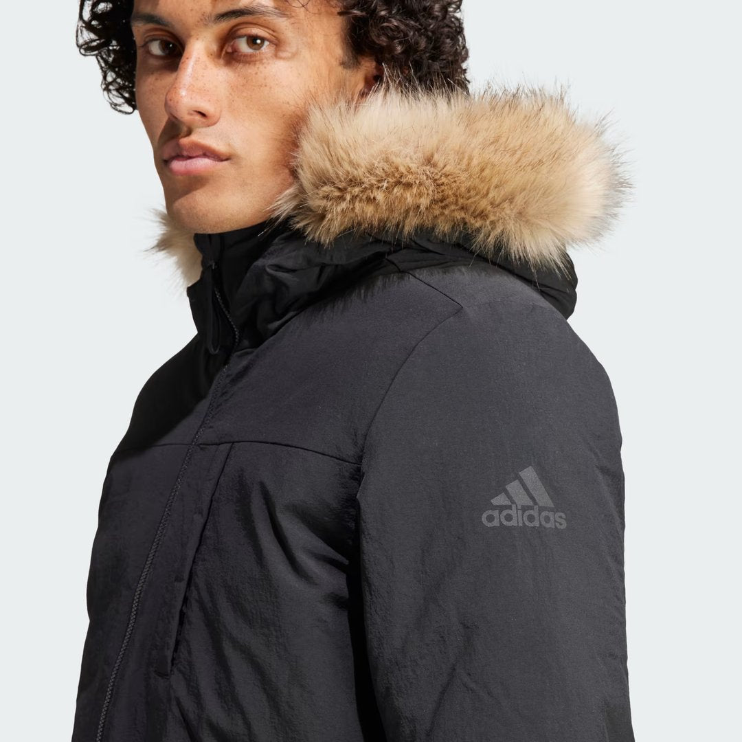 Close-up zoom on the fabric of the Adidas Hooded Fur Parka, showing the quilted puffer texture and subtle Adidas logo.