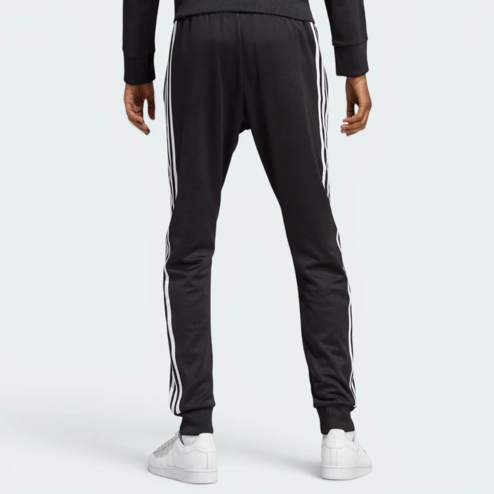 Focuses on the clean, uninterrupted fall of the black interlock fabric and the professional taper down to the ribbed cuffs.