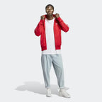 Model wearing the red adidas Firebird jacket
