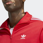 Detailed zoom on the ribbed stand-up collar and full zipper of the Adidas Adicolor Classics Firebird Track Jacket, highlighting its classic construction.
