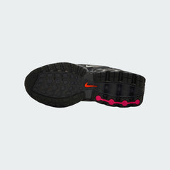 View of the outsole of the Nike Air Max DN Juniors' black running trainers, showing the durable rubber tread pattern and the unique design of the visible Dynamic Air pods.