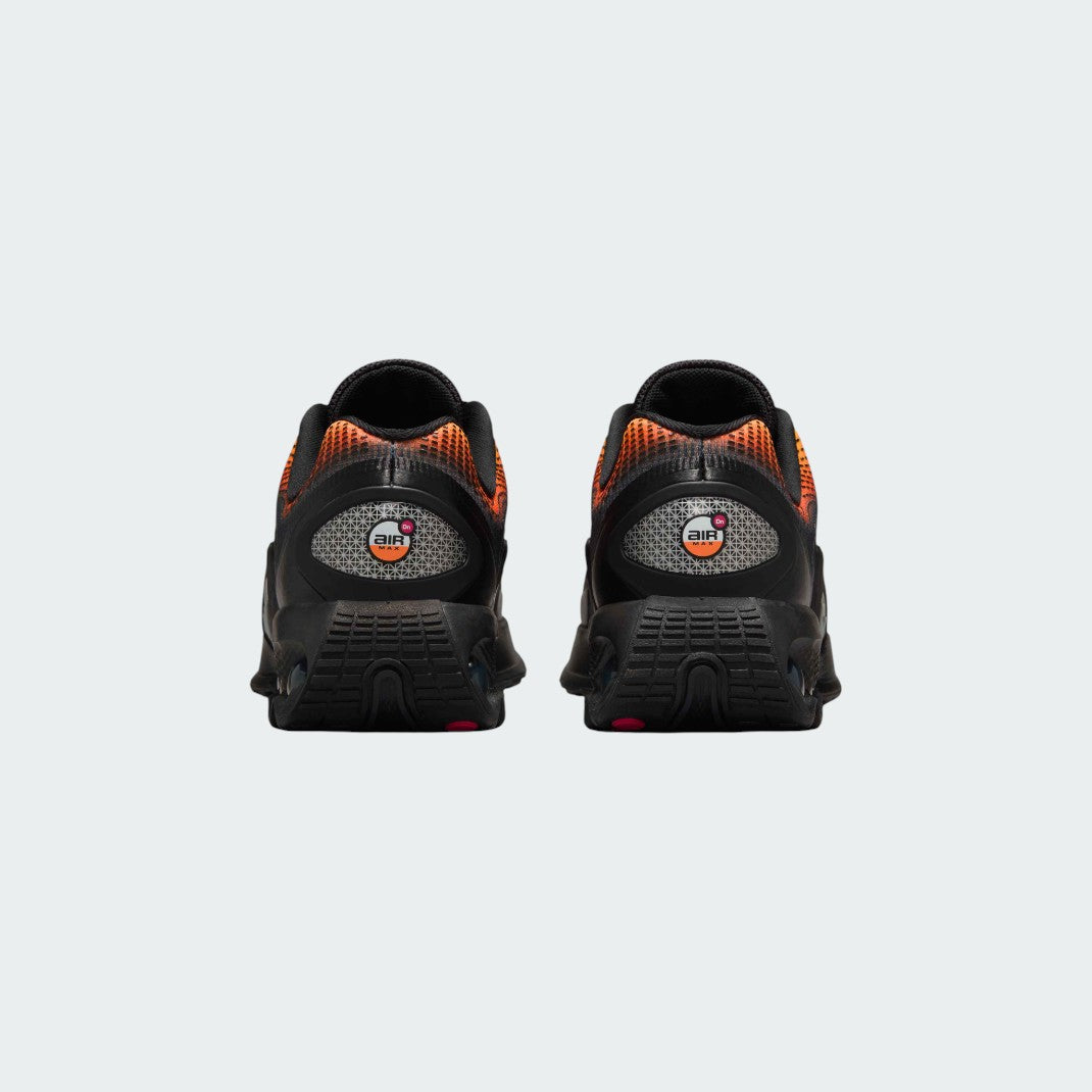 Rear view of the Nike Air Max DN Juniors' black running trainers, focusing on the visible Dynamic Air unit in the heel and molded heel counter.