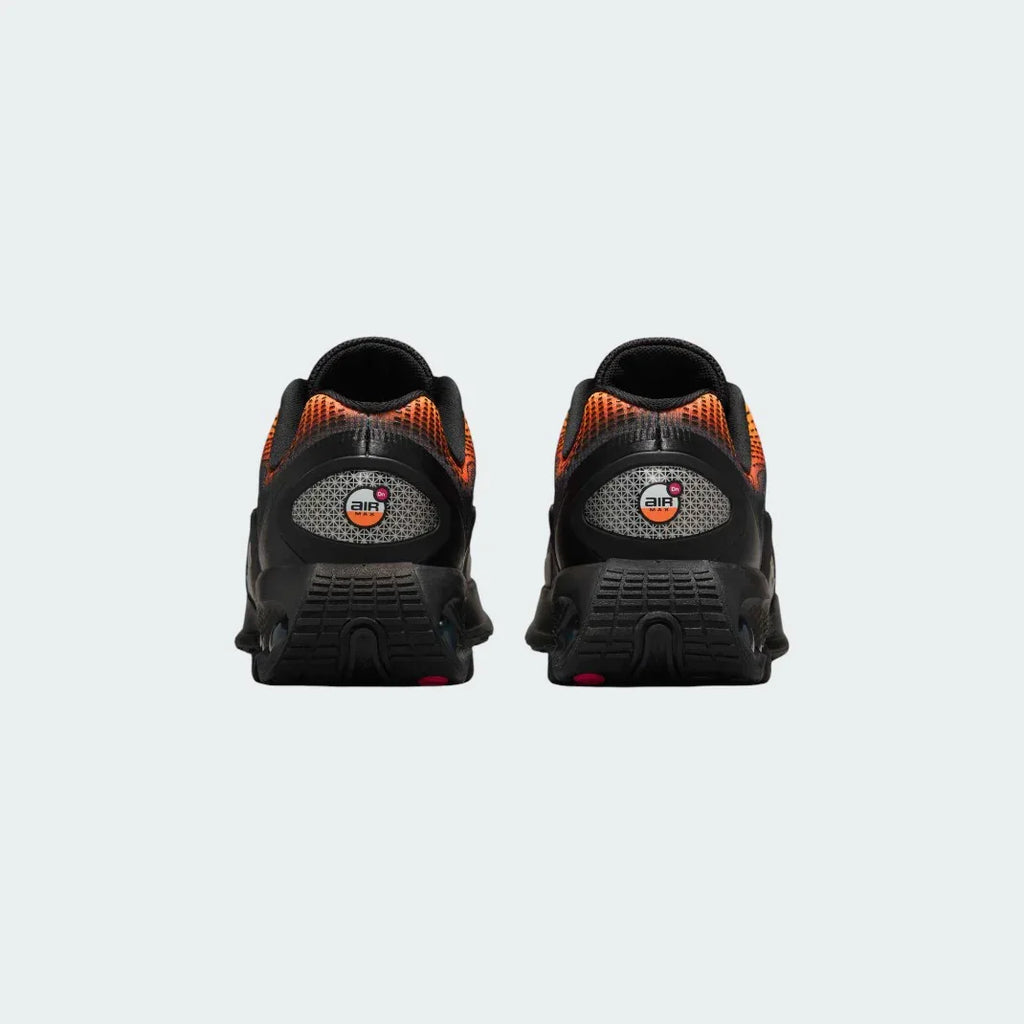 Rear view of the Nike Air Max DN Juniors' black running trainers, focusing on the visible Dynamic Air unit in the heel and molded heel counter.