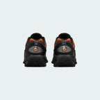 Rear view of the Nike Air Max DN Juniors' black running trainers, focusing on the visible Dynamic Air unit in the heel and molded heel counter.