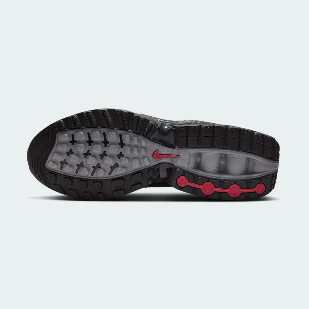 View of the outsole of the Nike Air Max DN Men's black running shoes, showing the durable rubber tread pattern and the unique design of the visible Dynamic Air pods.