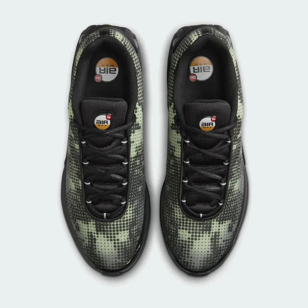 Top-down view of a pair of Nike Air Max DN Men's running shoes in black, highlighting their futuristic design and lace-up closure.