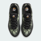 Top-down view of a pair of Nike Air Max DN Men's running shoes in black, highlighting their futuristic design and lace-up closure.