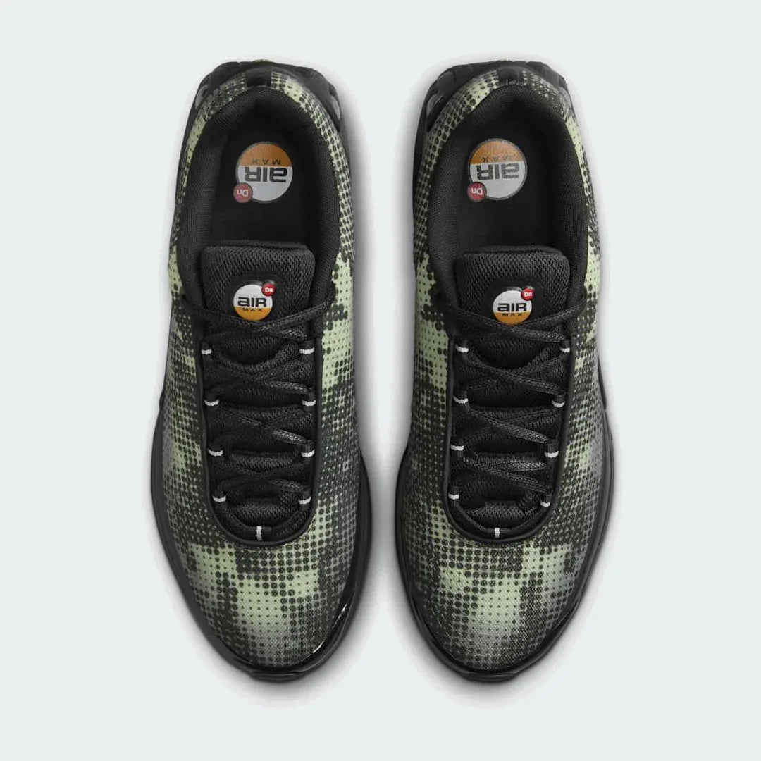 Top-down view of a pair of Nike Air Max DN Men's running shoes in black, highlighting their futuristic design and lace-up closure.