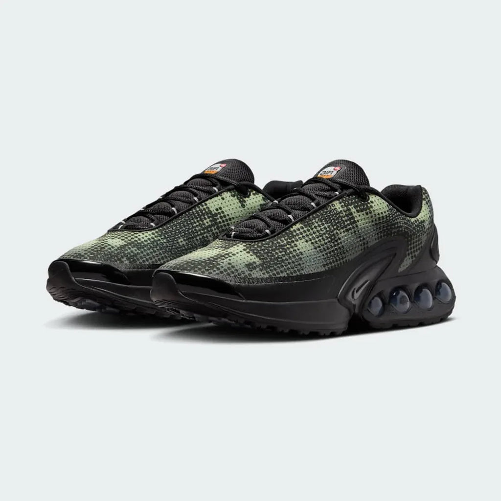 Angled view of two Nike Air Max DN Men's black running shoes, side by side, showcasing their bold, modern design and prominent Air unit.