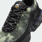 Close-up zoom on the front of the Nike Air Max DN Men's black running shoes, showing the mesh upper texture, haptic print details, and lacing system.