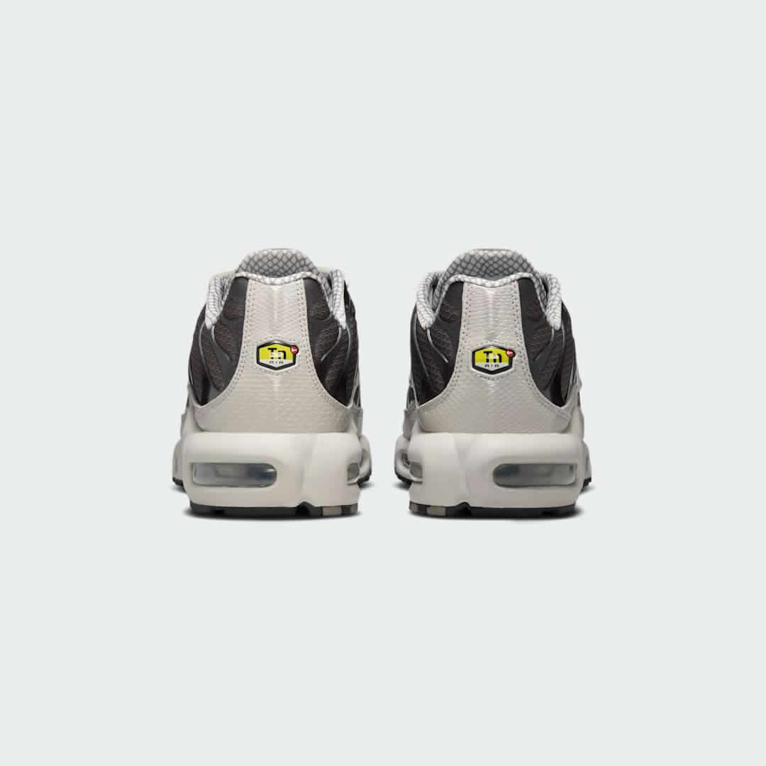 Rear view of the Nike Air Max Plus TN Men's trainers, focusing on the prominent Tuned Air branding on the heel and wavy design elements.