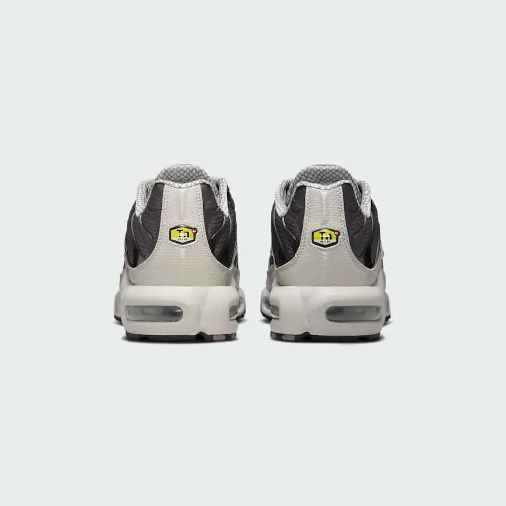 Rear view of the Nike Air Max Plus TN Men's trainers, focusing on the prominent Tuned Air branding on the heel and wavy design elements.