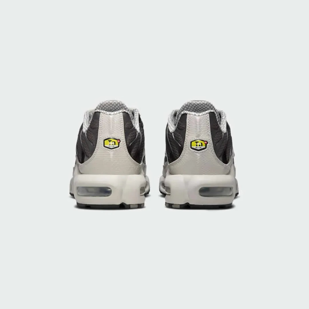 Rear view of the Nike Air Max Plus TN Men's trainers, focusing on the prominent Tuned Air branding on the heel and wavy design elements.