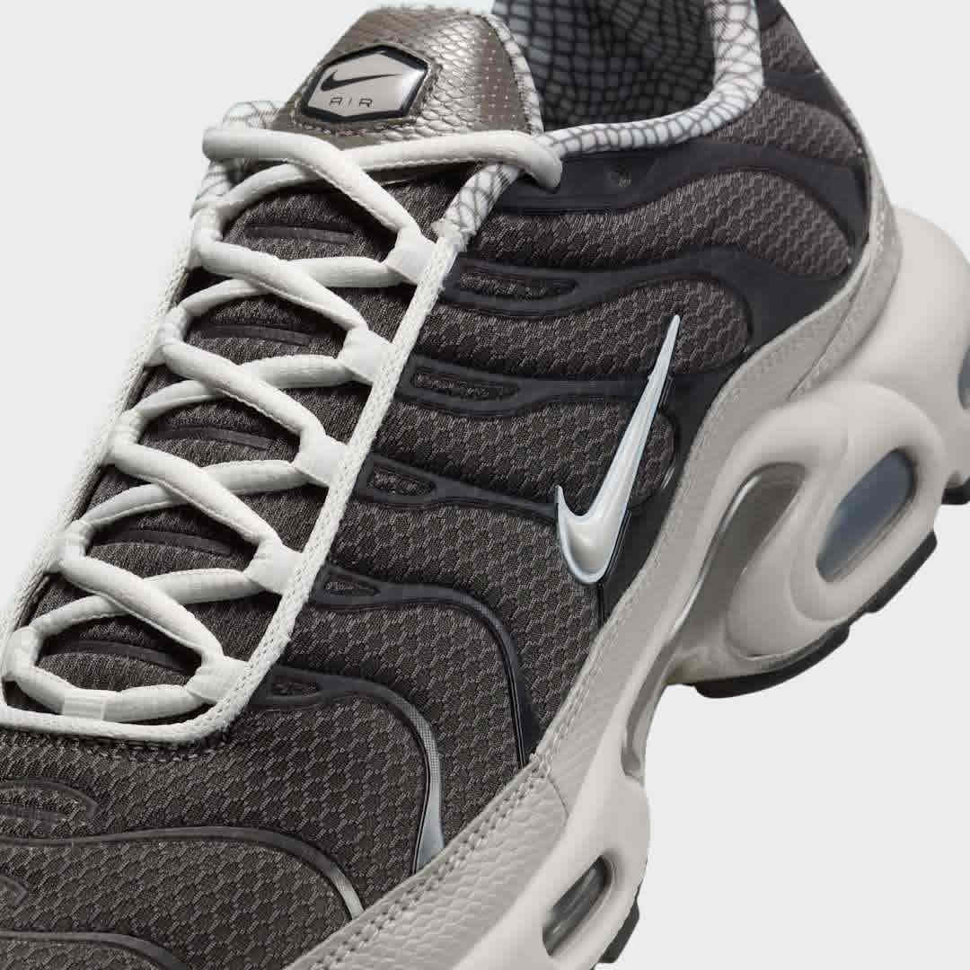 Close-up zoom on the front of the Nike Air Max Plus TN Men's trainers, showing the mesh toe box, lacing system, and intricate wavy overlays.
