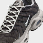 Close-up zoom on the front of the Nike Air Max Plus TN Men's trainers, showing the mesh toe box, lacing system, and intricate wavy overlays.