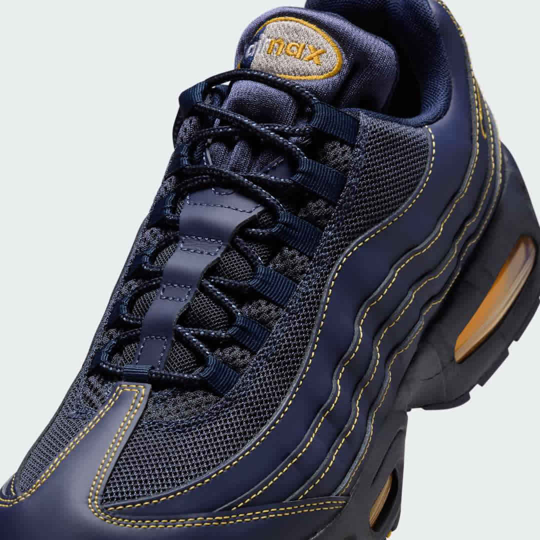 Close-up zoom on the front of the Nike Air Max 95 OG Men's running shoes, showing the intricate lacing system, mesh tongue, and layered overlays.