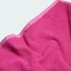 Close-up detail of the Adidas Cotton Sports Towel in pink, showing the plush texture of the absorbent 100% cotton material.