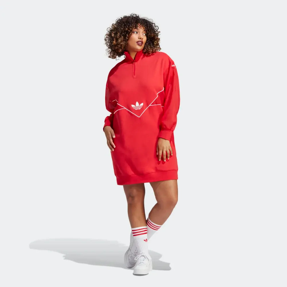 Front profile modern worn of the Adidas Archival Oversize Dress in Better Scarlet red, showing the long sleeves, ribbed cuffs, and the relaxed, modern silhouette.