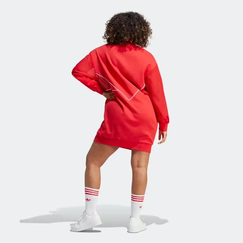 back profile modern worn of the Adidas Archival Oversize Dress in Better Scarlet red, showing the long sleeves, ribbed cuffs, and the relaxed, modern silhouette.
