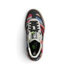 Top-Down View of Pair/Item: Overhead view looking down at the laced striped shoes, displaying the black flat laces, co-branded tongue label, and printed KSENIASCHNAIDER insole.   