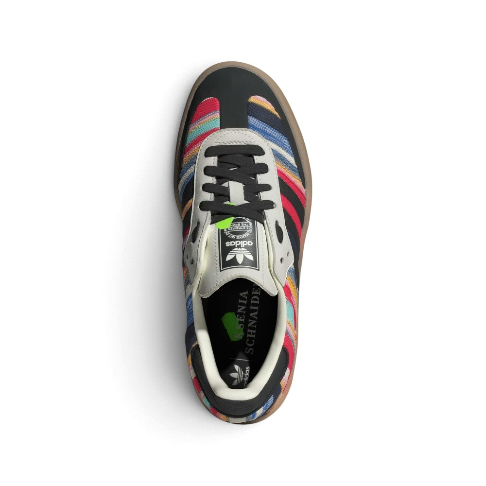 Top-Down View of Pair/Item: Overhead view looking down at the laced striped shoes, displaying the black flat laces, co-branded tongue label, and printed KSENIASCHNAIDER insole.   