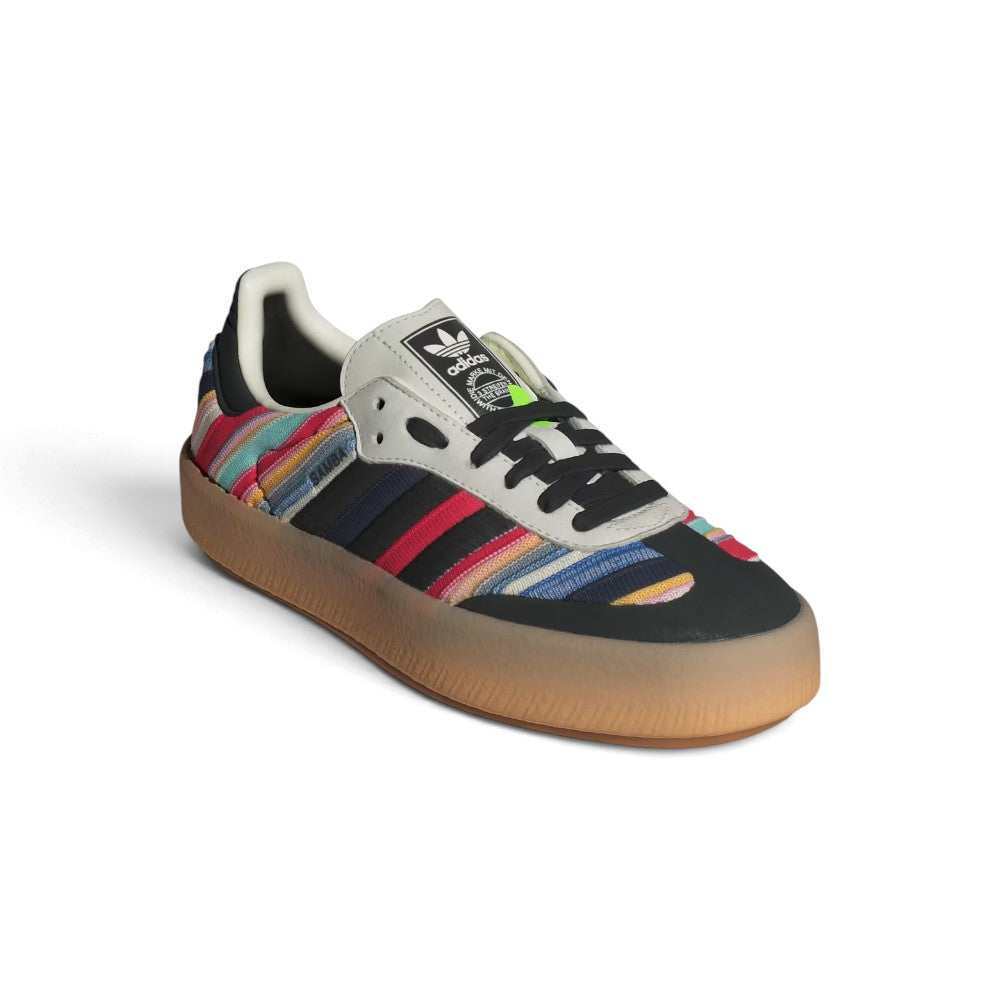 Angle View Showing Details Side by Side: Angled front-three-quarter perspective capturing the stitched black toe cap, multicolored woven side panels, and integrated embroidered striping.   