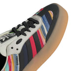 Zoom Looking at the Front of the Shoes and Laces: Macro focus on the black stitched mudguard overlay, ivory eyestays, and matching black flat laces.   