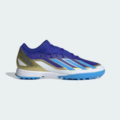Adidas X Crazyfast League TF football boots in lucid blue with white and gold accents, side profile showing the textured synthetic upper and turf-specific rubber sole.