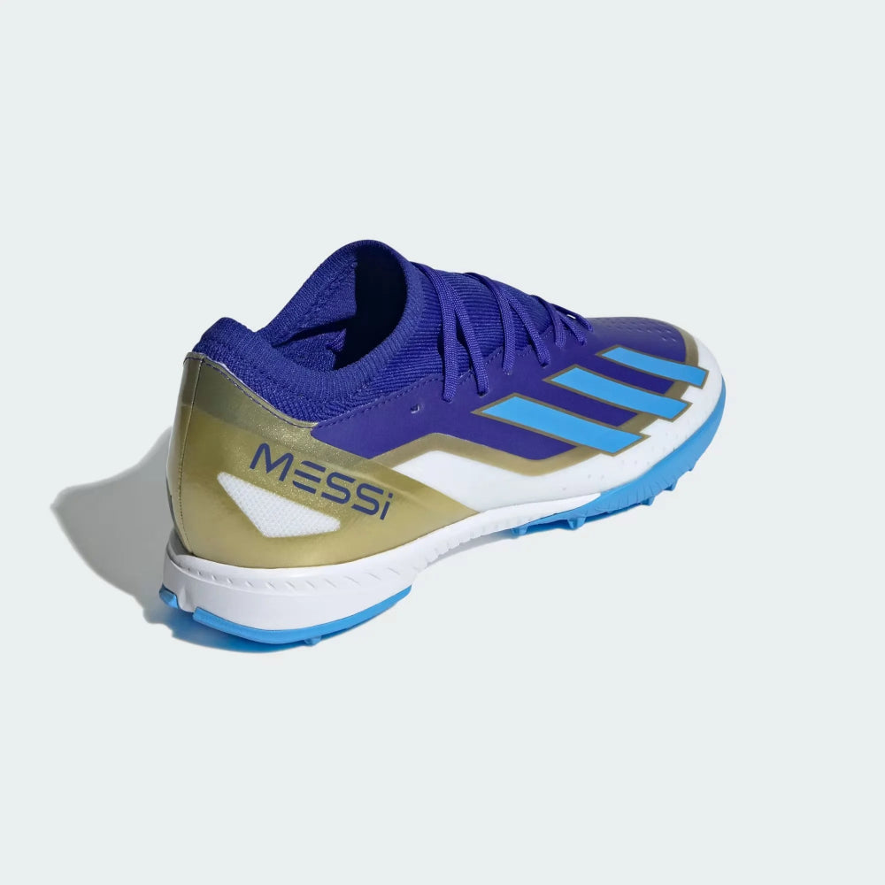 Angled view of two Adidas X Crazyfast League TF boots in blue and white, view from the rear down the side featuring messi text