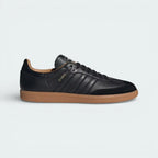 Side profile of the adidas Samba OG Made In Italy in Core Black, showing the premium Italian leather texture and the iconic white 3-Stripes.