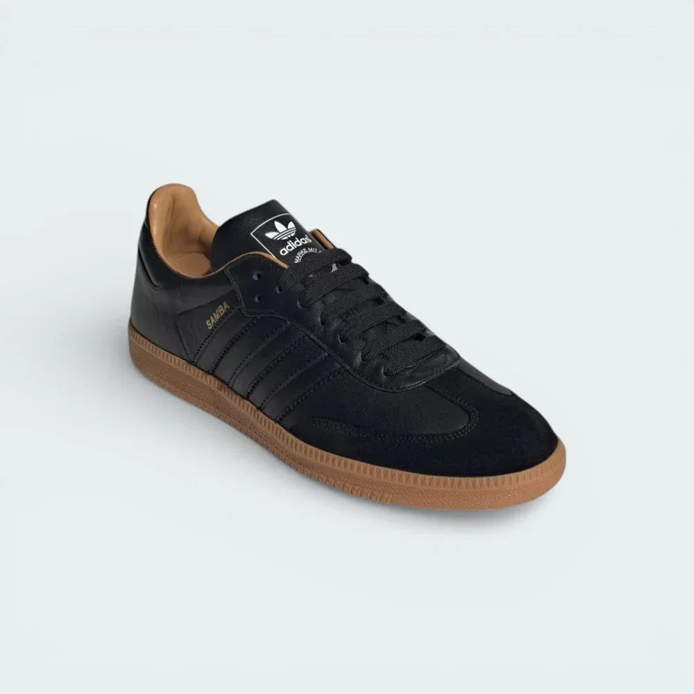 Angled shot of the Samba OG Made In Italy shoes, showcasing the refined silhouette and the contrast between the black leather and gum accents.
