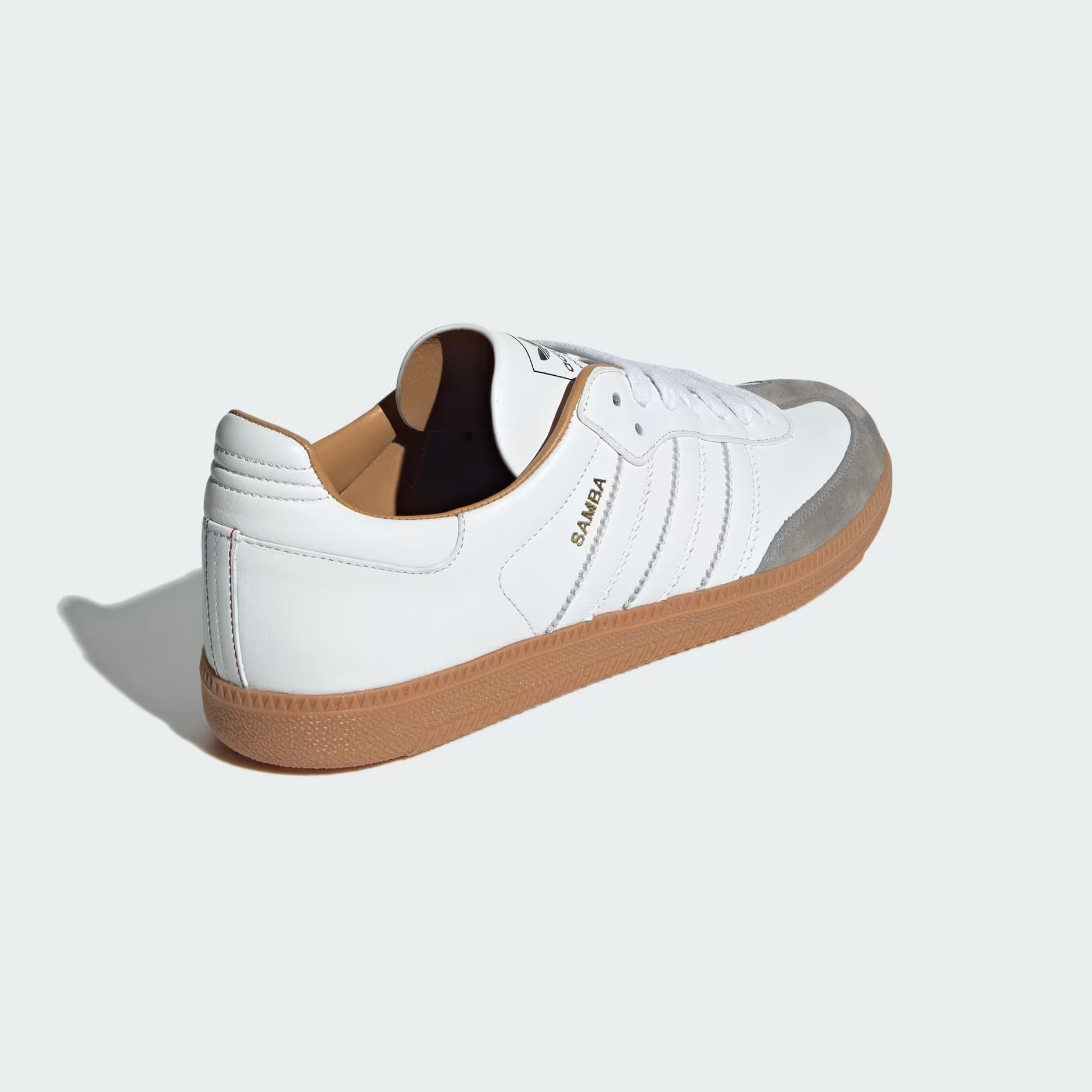 Focuses on the contoured shape of the leather-lined collar, highlighting the clean Core White leather heel overlay stitched cleanly into the rear spine.