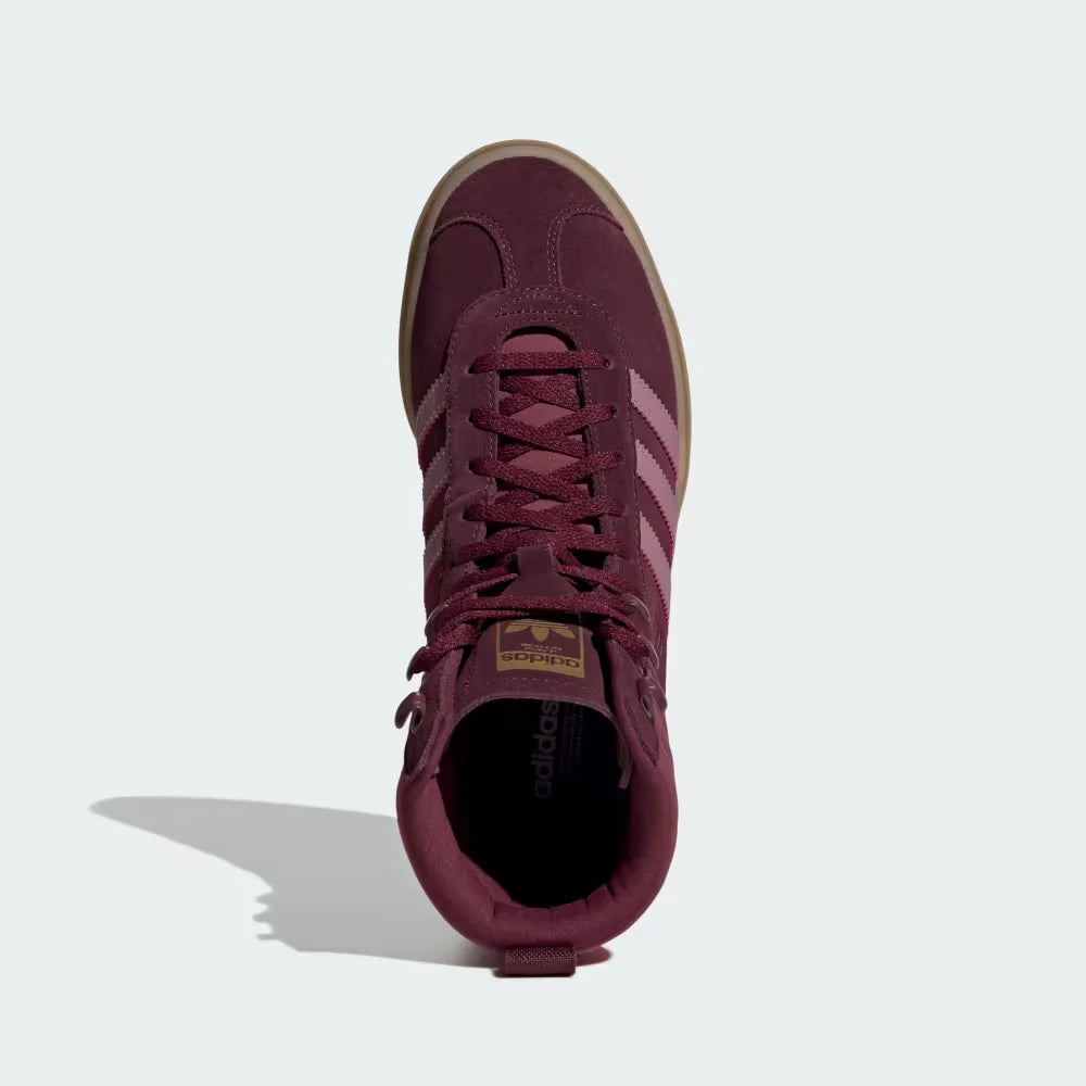 Looking down at the maroon suede lacing system and the tonal branding on the tongue.
