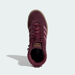 Looking down at the maroon suede lacing system and the tonal branding on the tongue.