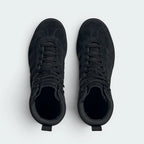Focuses on the locked-in lace configuration, the textured tongue with the Trefoil branding, and the soft textile lining.