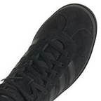 Details the high-definition finish of the suede T-toe overlay and the premium quality of the black eyelets.