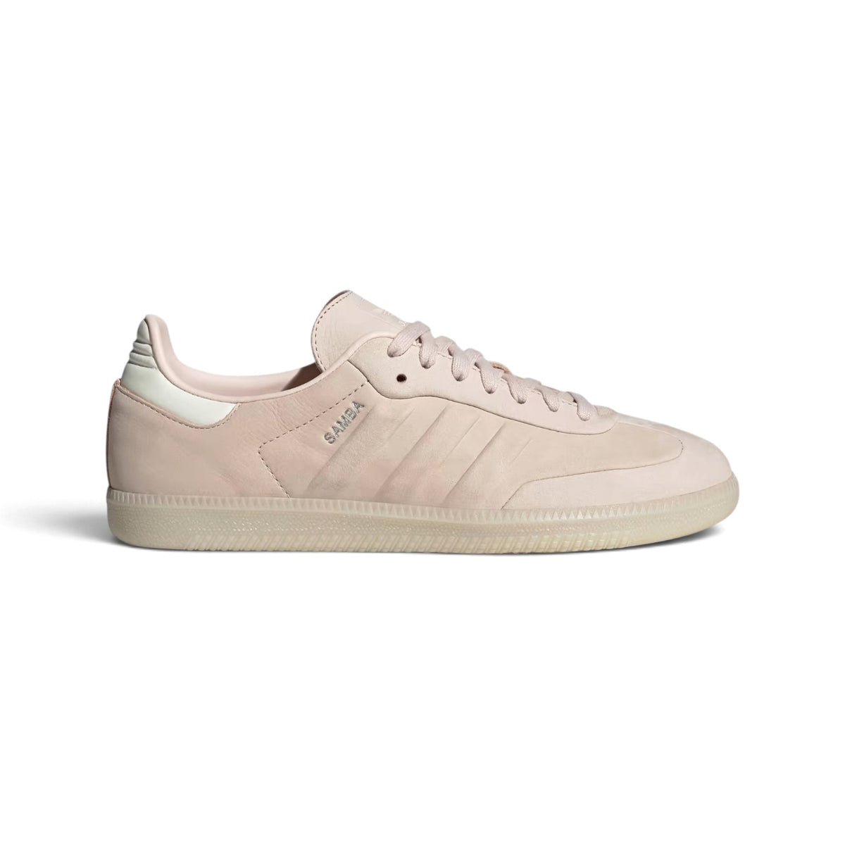 Side Profile Image: Studio lateral shot of the minimalist adidas Samba in soft tonal pink, highlighting the smooth leather upper, subtle debossed three stripes, silver foil SAMBA lettering, and translucent gum rubber outsole.    Main image