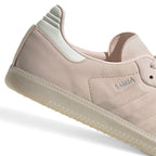 Zoom Looking at the Outsole and Midsole: Detailed close-up angle capturing the textured sidewall profile of the gum rubber midsole meeting the branded silver foil quarter panel.   