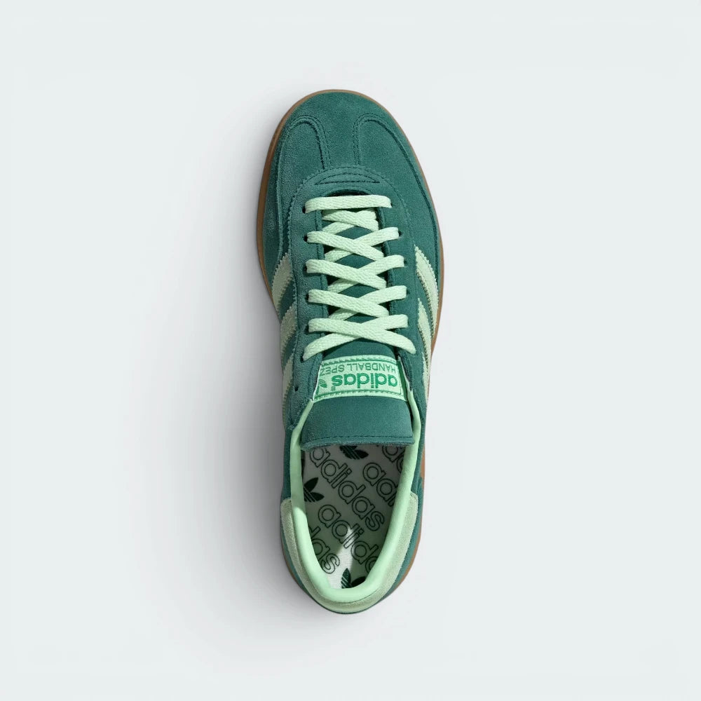 Focuses on the locked-in lace closure layout, the clean alignment of the soft suede tongue, and the iconic symmetrical toe guard paneling covering the front box.