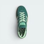 Focuses on the locked-in lace closure layout, the clean alignment of the soft suede tongue, and the iconic symmetrical toe guard paneling covering the front box.
