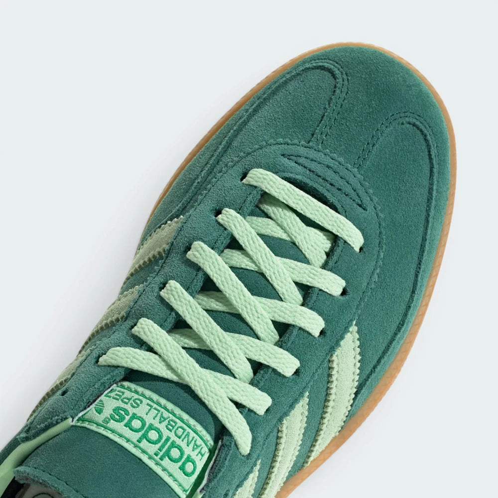 Details the premium dual-stitching lines crossing the velvety suede toe box and the precision lace eyelet configuration.