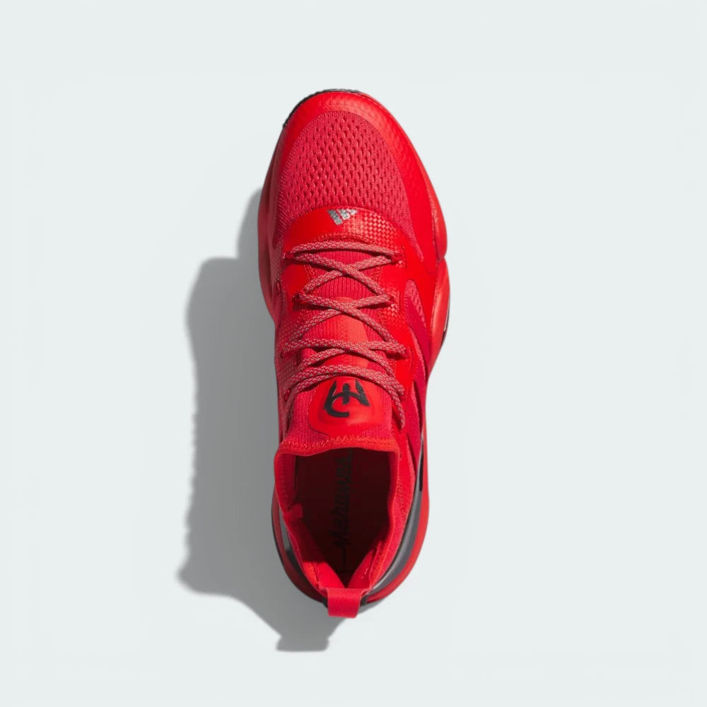 Top-down view of the red training shoes, highlighting the integrated lacing system and the textile tongue detailing.