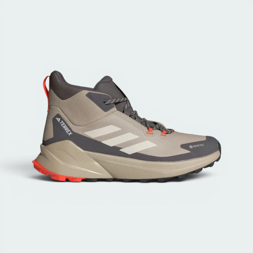 Highlights the high-velocity lines of the seamless overlays, the crisp Terrex branding, and the professional look of the mid-height ankle cuff resting above the charcoal mudguard.